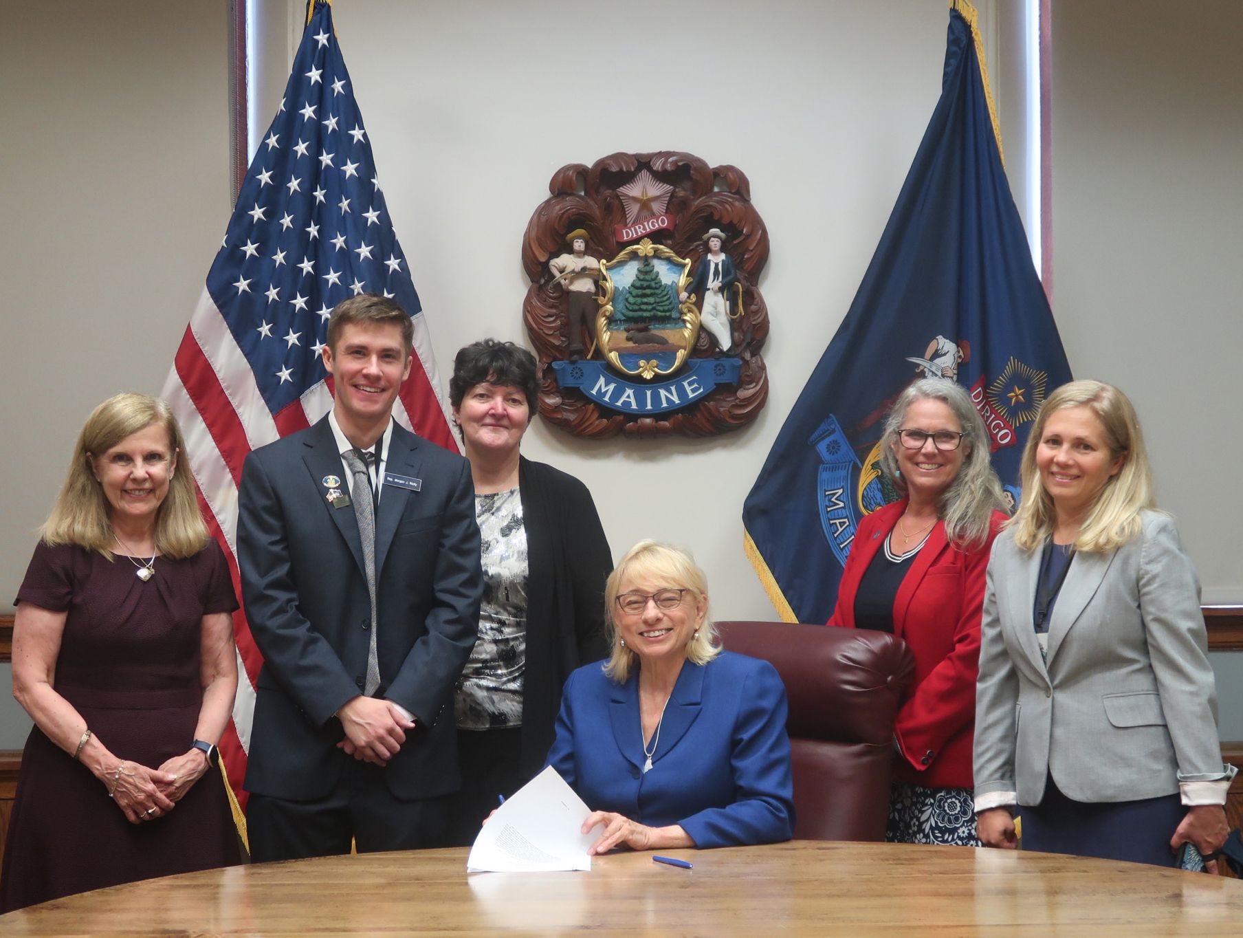a group of elected officials sign a bill