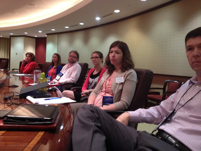 photo of people sitting around a conference table